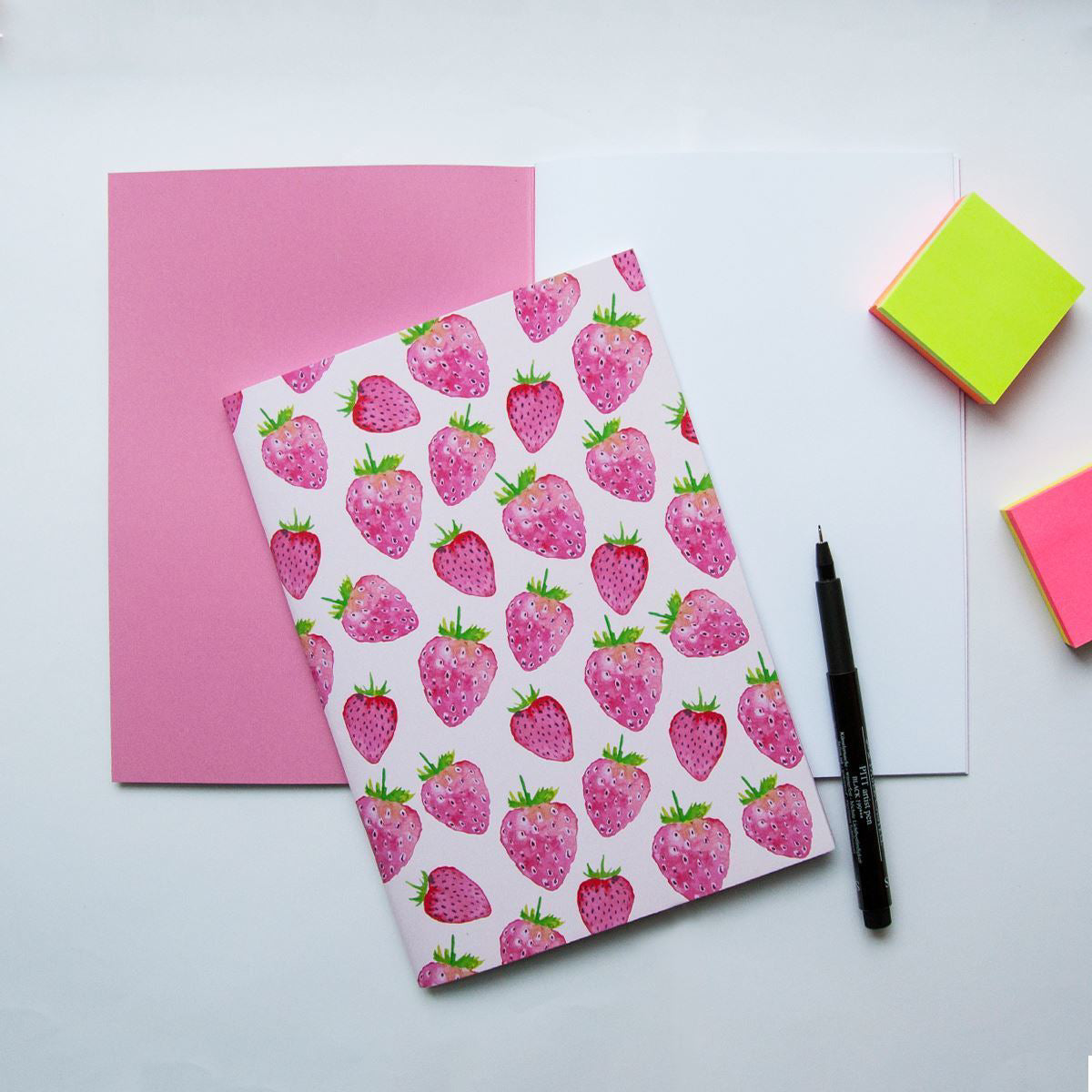 Notebook with strawberry pattern on a white background