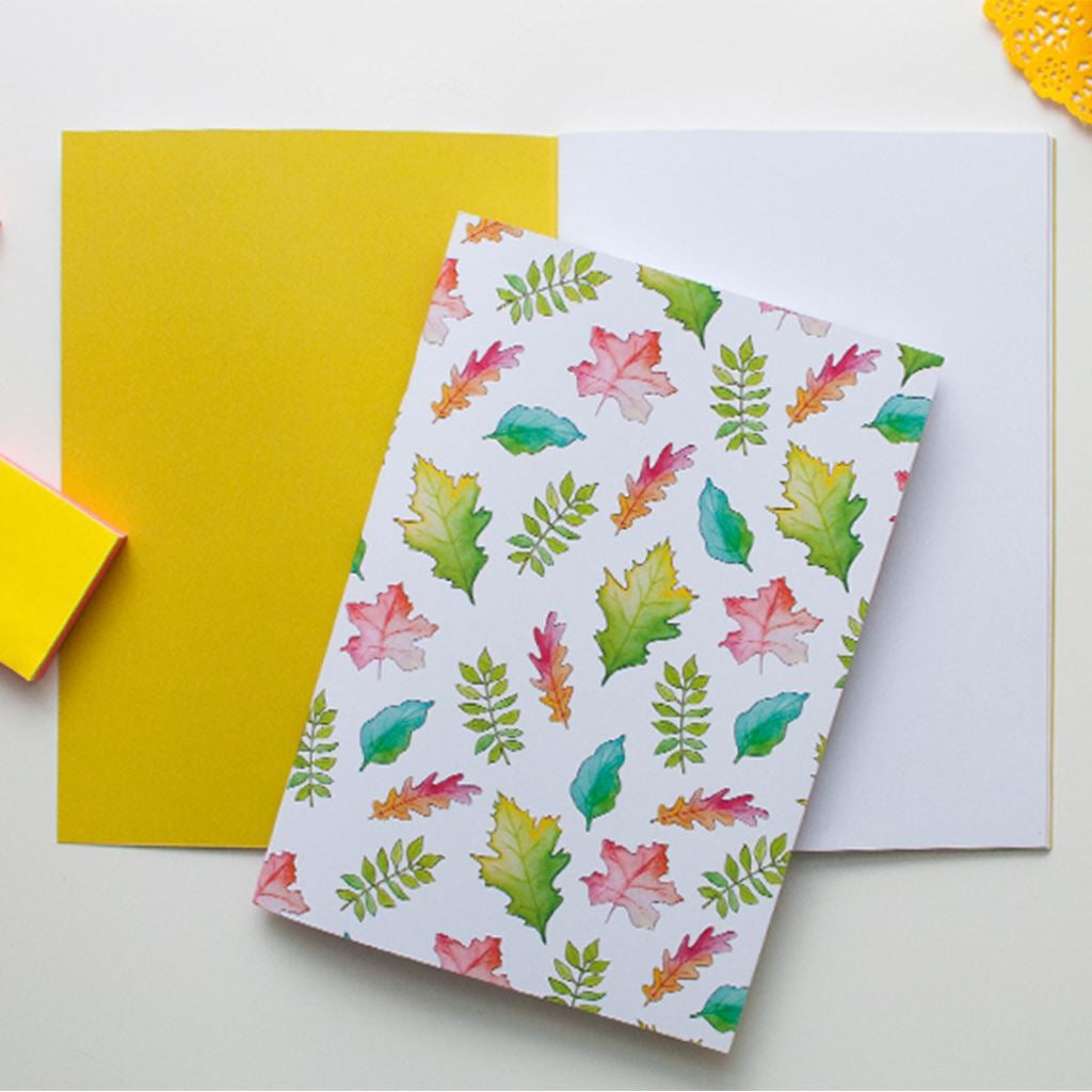 Notebook with colorful leaf pattern on a white background