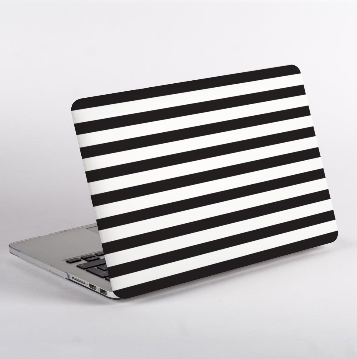 Side View of Black and white striped pattern MacBook case on a MacBook with white background.