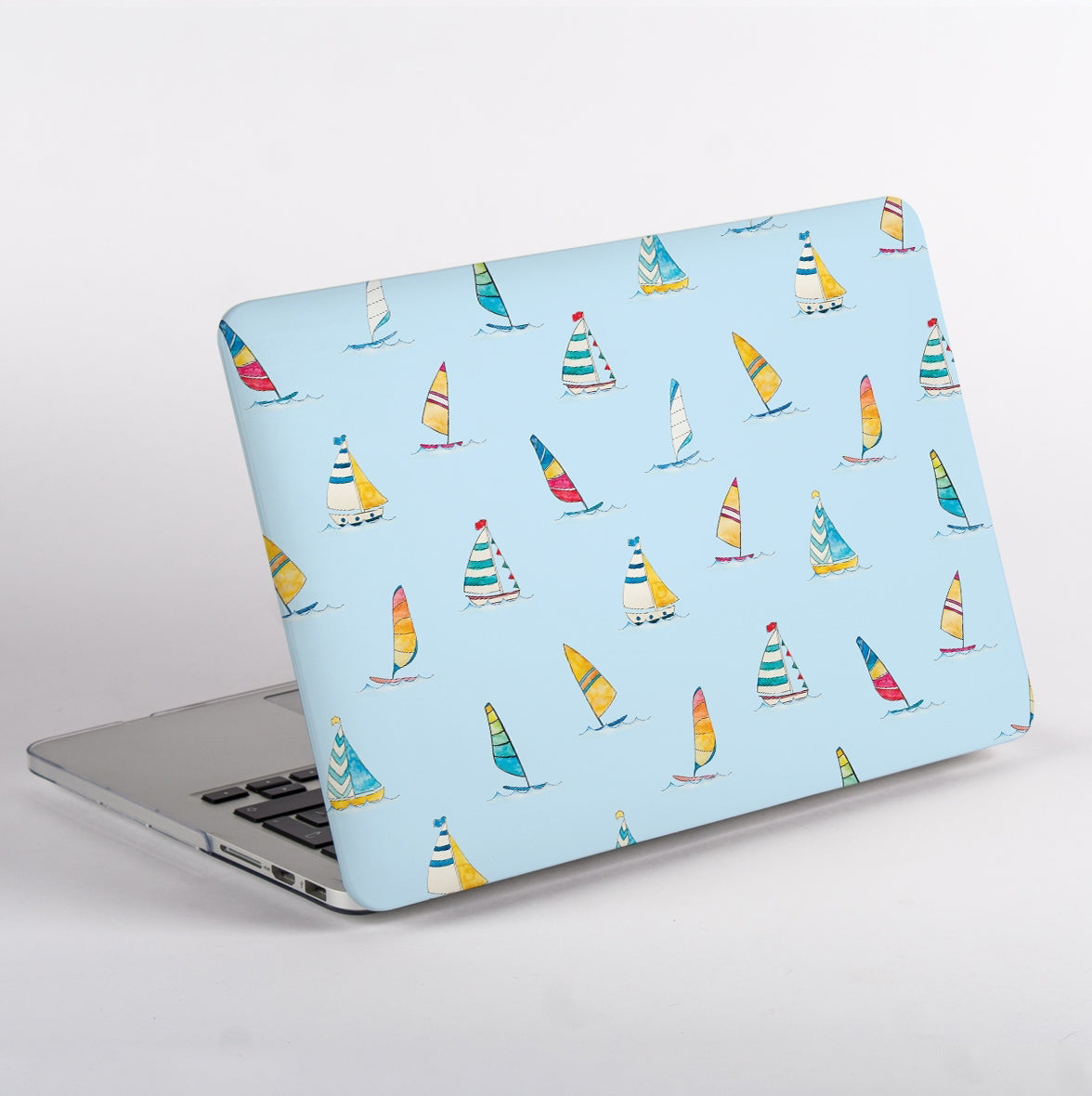 Side View of MacBook with colorful sailboat pattern case on a light blue background