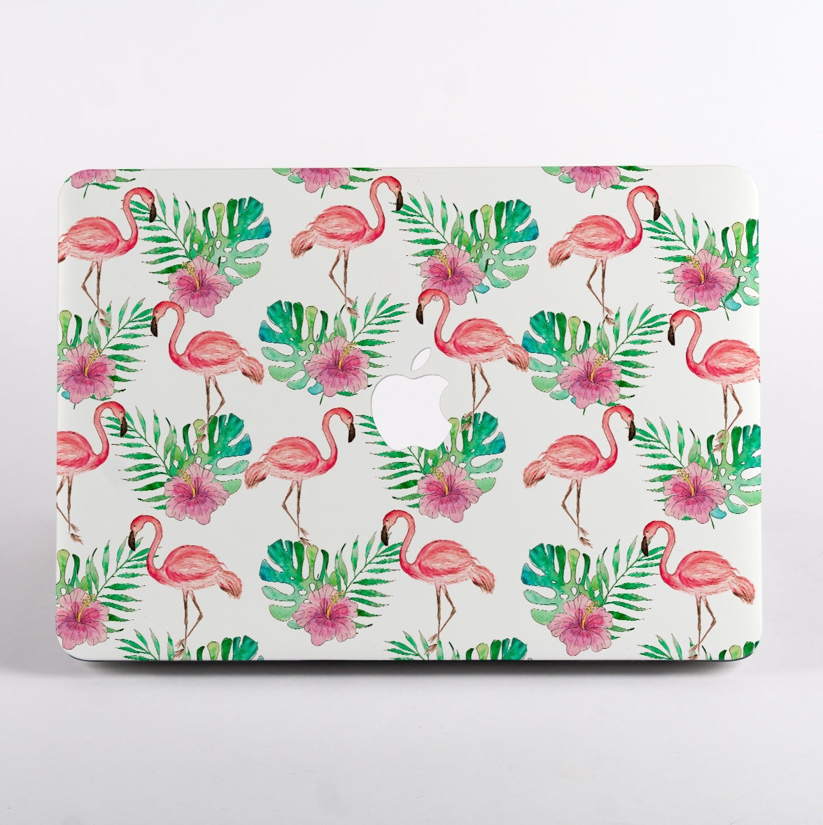 MacBook with a flamingo and leaf pattern case on a white background