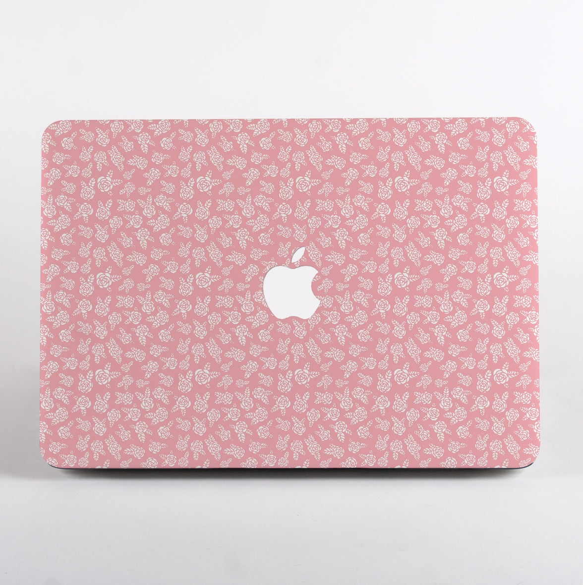 MacBook with Pink floral pattern and Apple logo Case on a light gray background