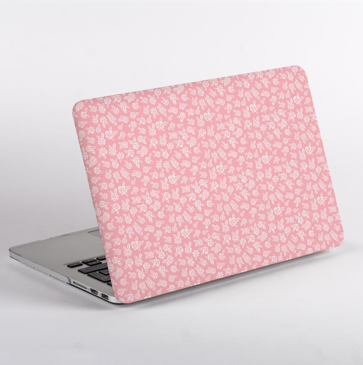 Side view of MacBook with Pink floral pattern and Apple logo Case on a light gray background