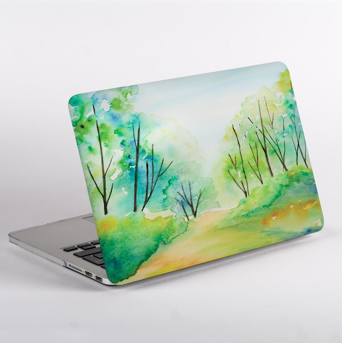 Side view of MacBook with watercolour forest painting case.