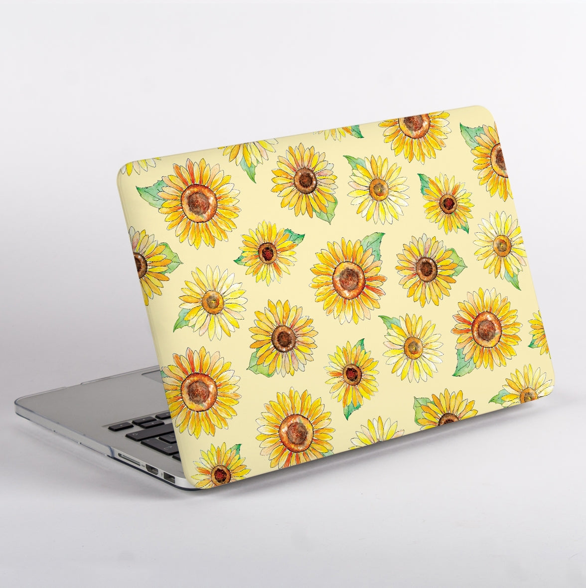 Side view of a Macbook with a sunflower patterned case on a light grey background