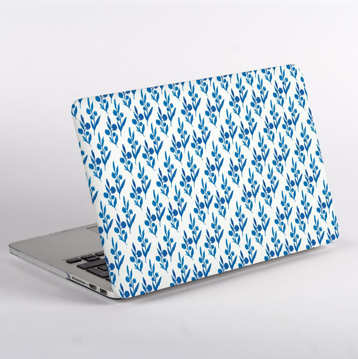 Side View MacBook with blue leaf pattern case on a white background