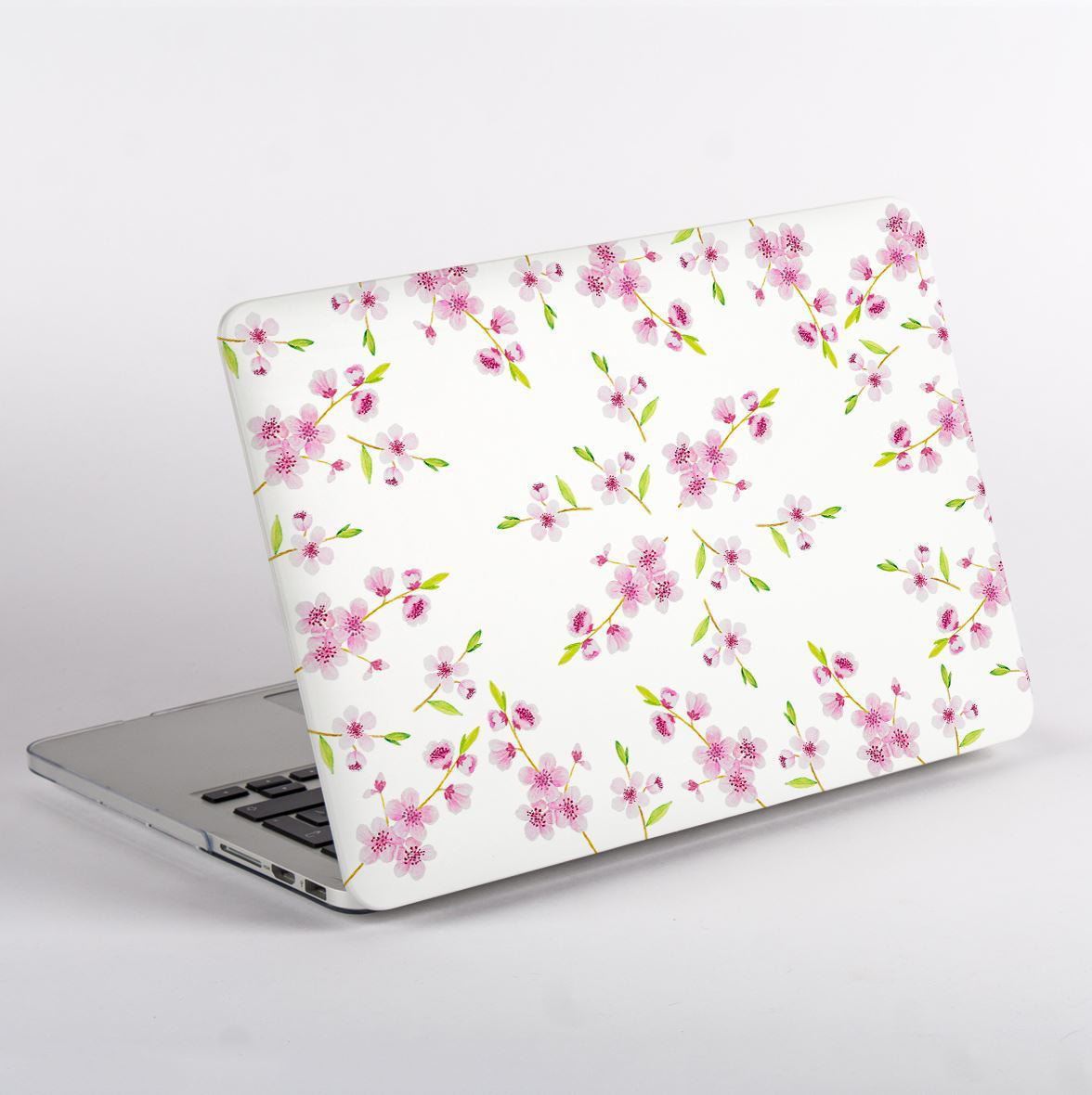 MacBook with a floral design case on a white background