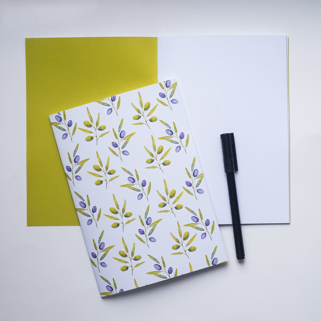 Notebook with folive design, and black pen on a white background