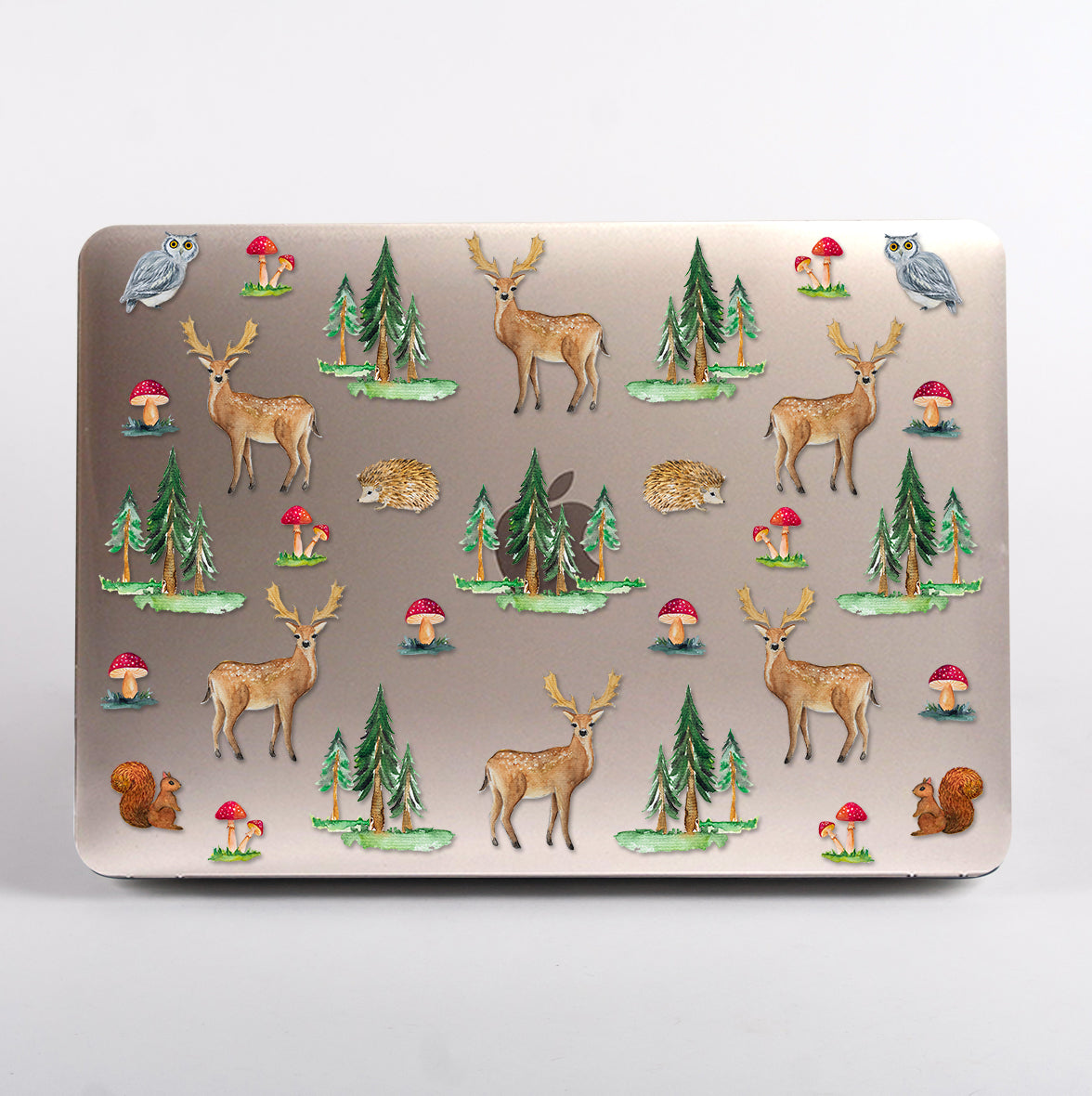 MacBook with a nature-themed design featuring deer, trees, and mushrooms clear case