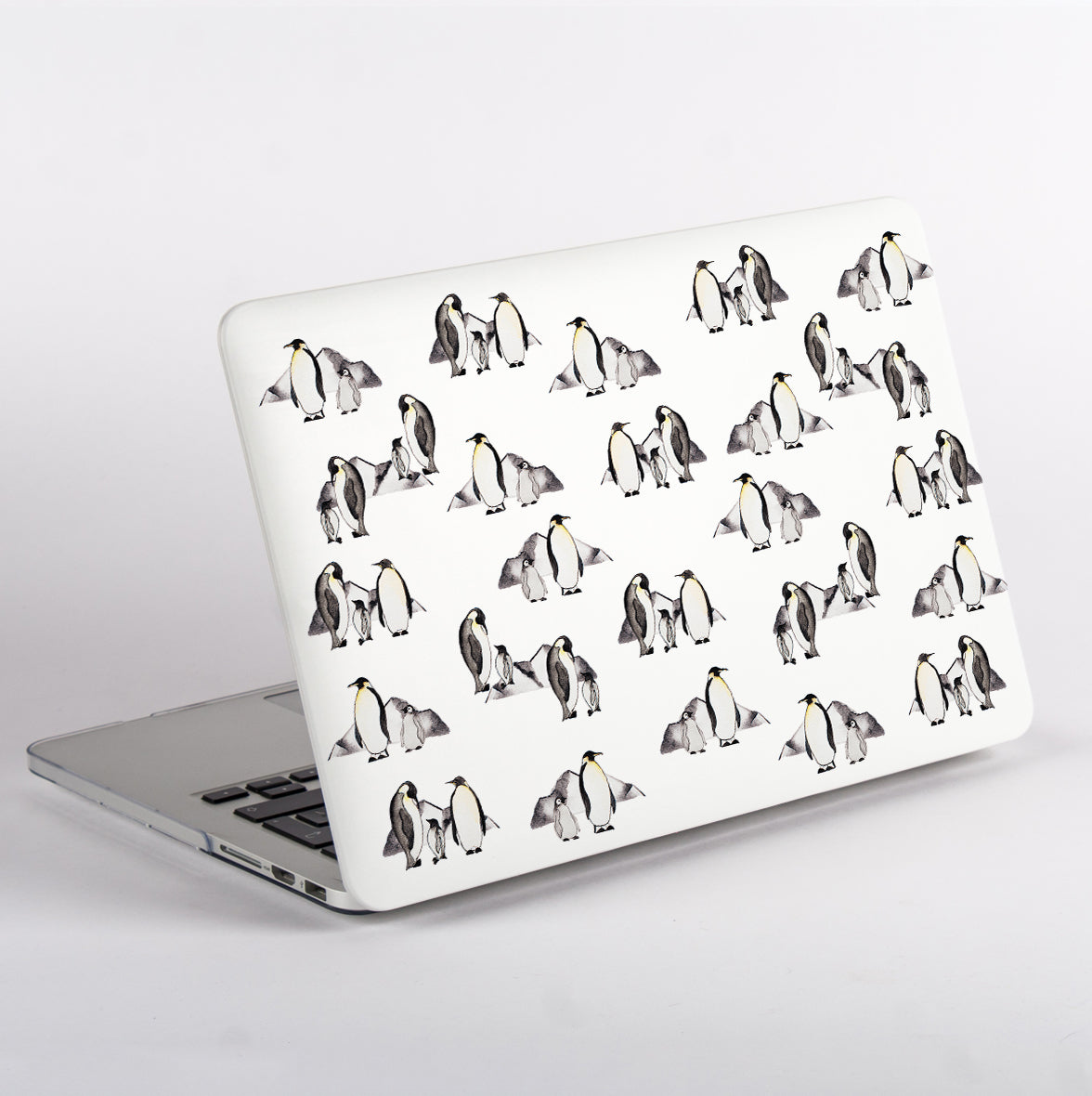 MacBook with penguin patterned case on a white background