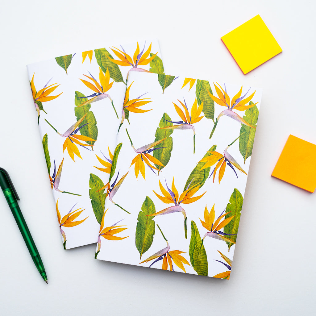 Two notebooks with a tropical flower pattern on a white background
