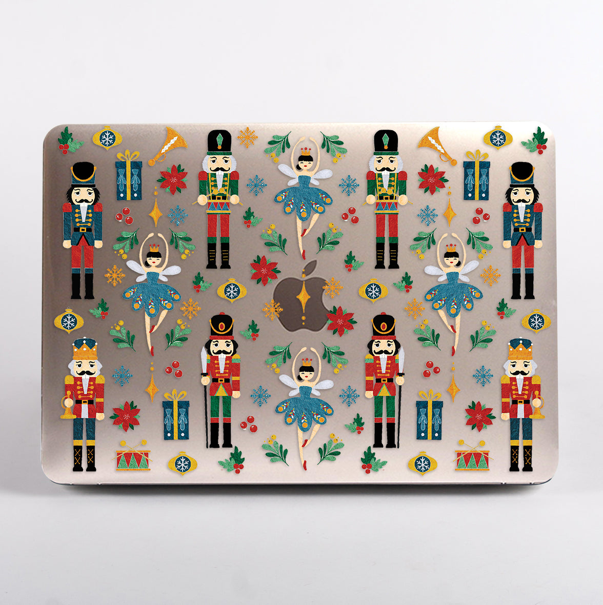MacBook with a Christmas-themed case featuring nutcrackers and ballerinas