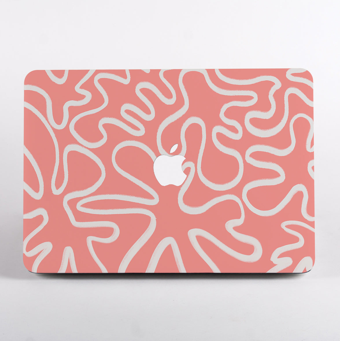 MacBook with a pink and white abstract pattern case