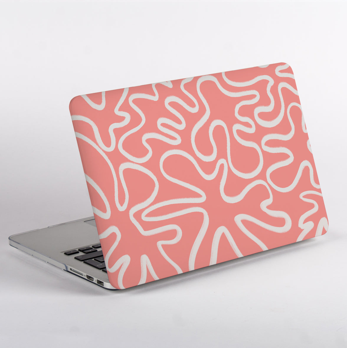 Sid view of MacBook with a pink and white abstract pattern case