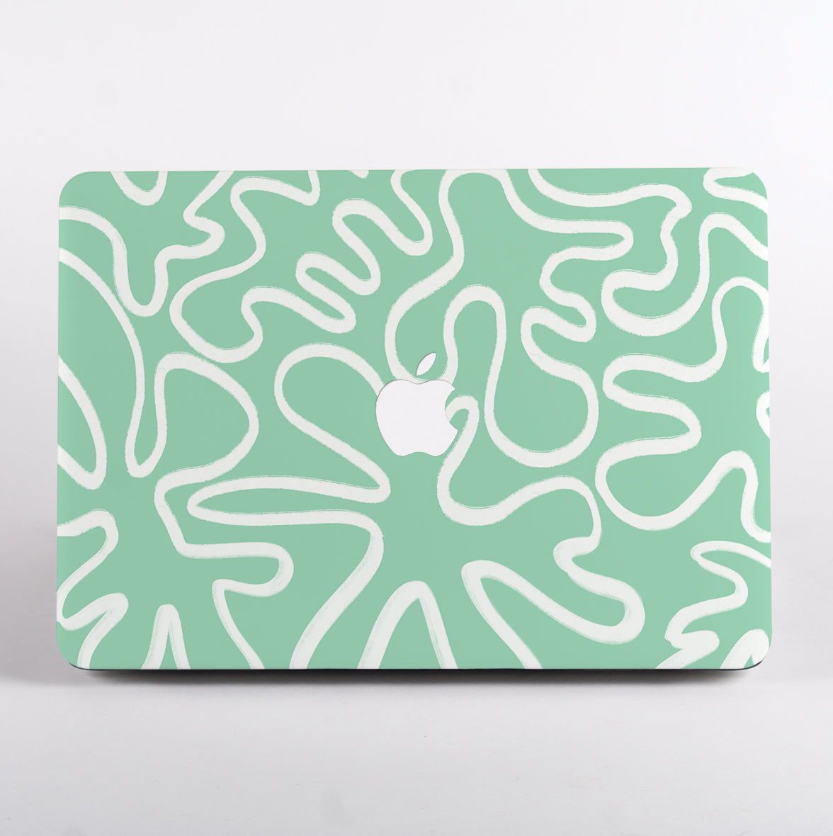 MacBook with mint green and white line patterned case