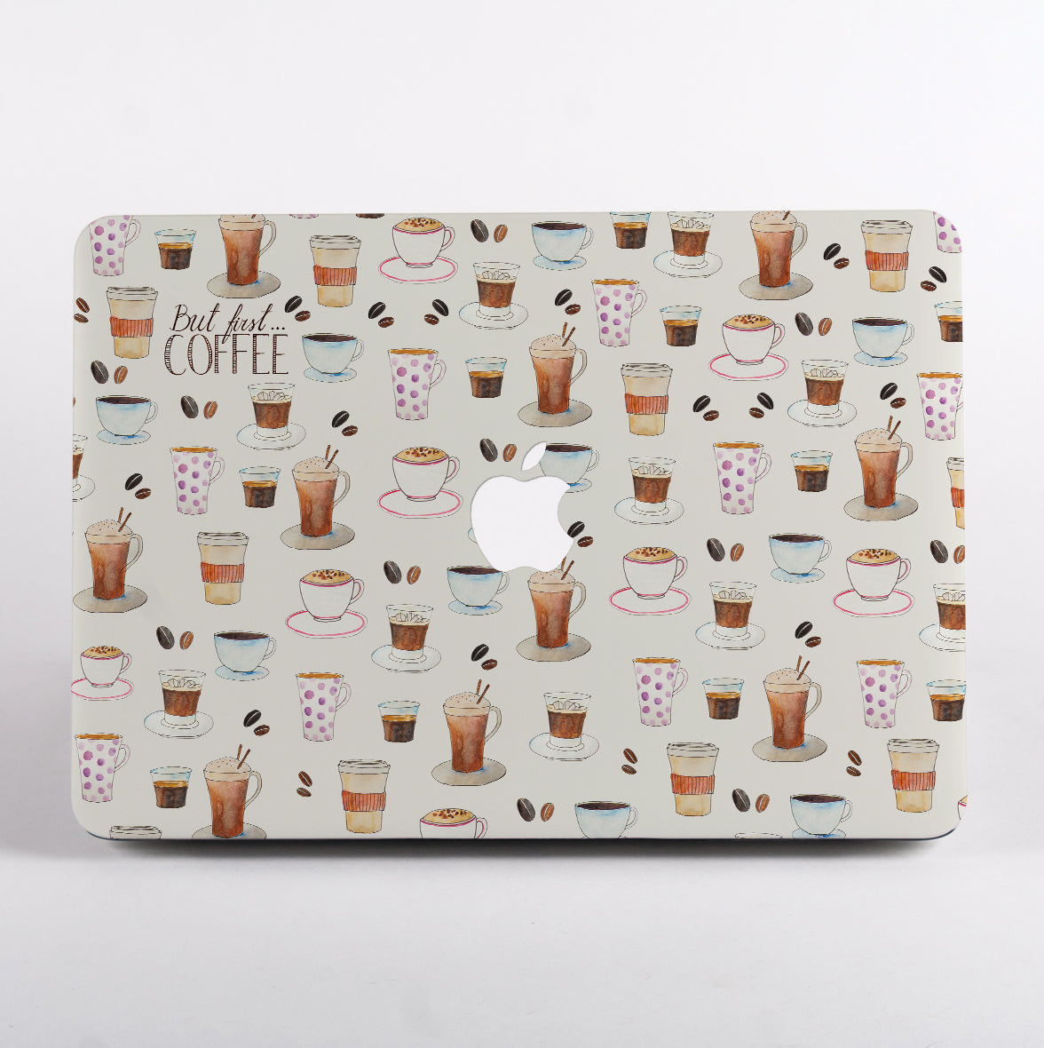 MacBook with a coffee-themed case on a white background