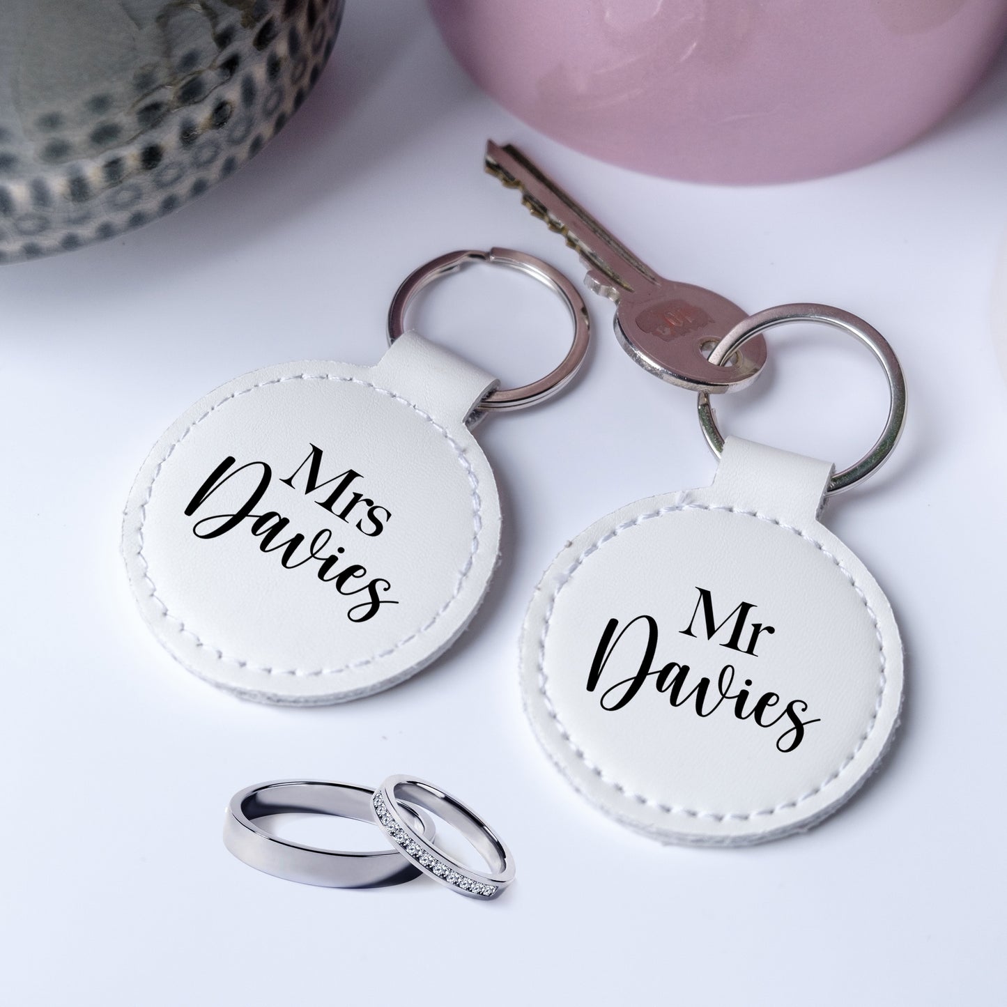 A set of two leather keyrings with black writing Mr and Mrs, personalised with the family name, perfect gift for newelyweds.