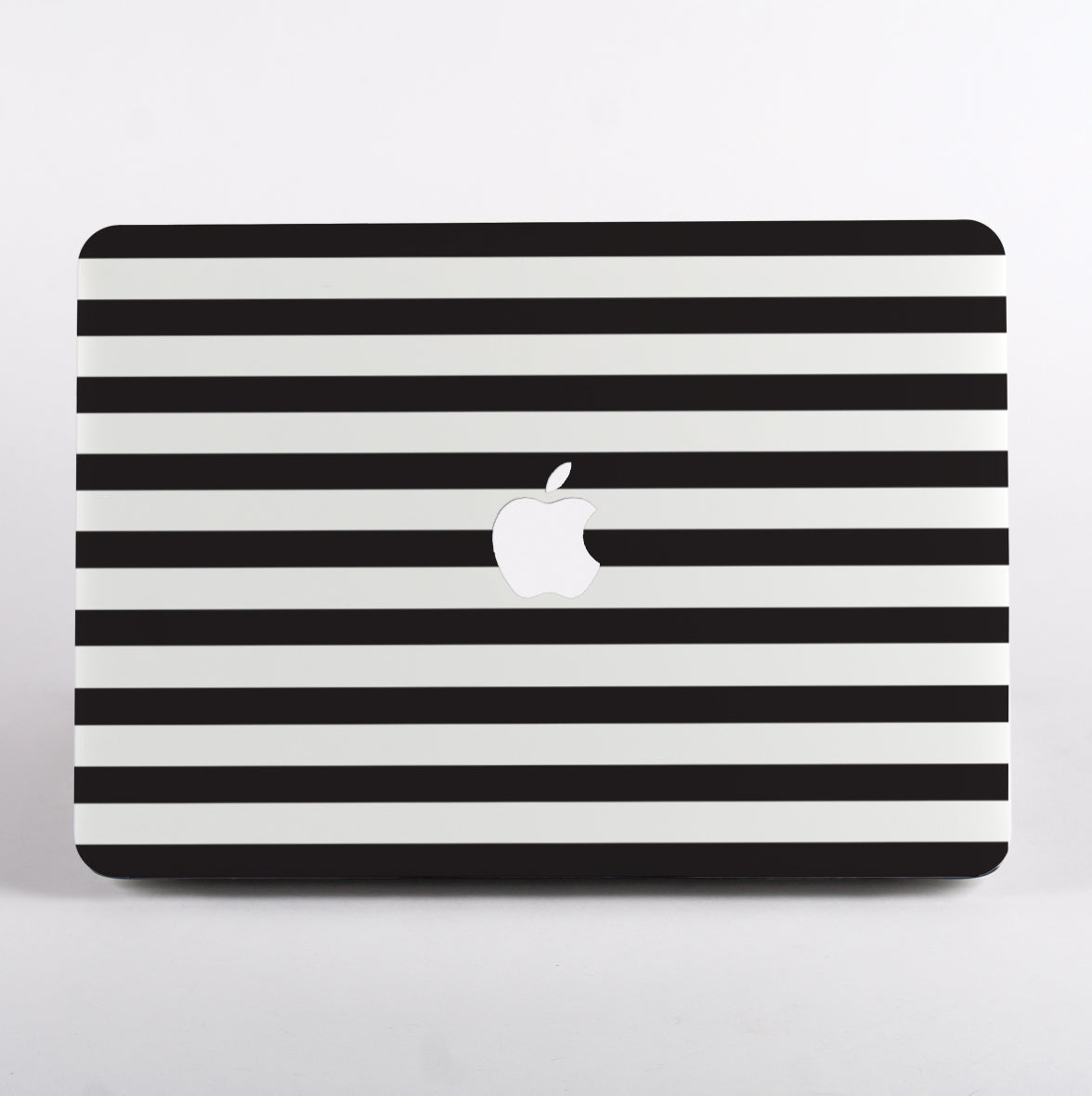 Black and white striped pattern MacBook case on a MacBook with white background.