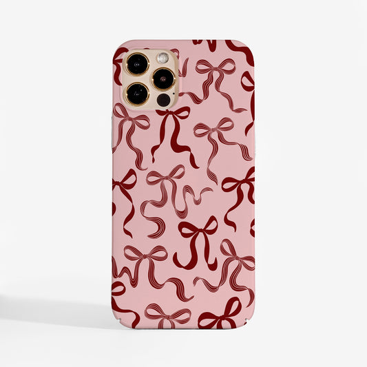 Cuteand elegant Christmas phone case with pretty ribbon design on a soft pink background.