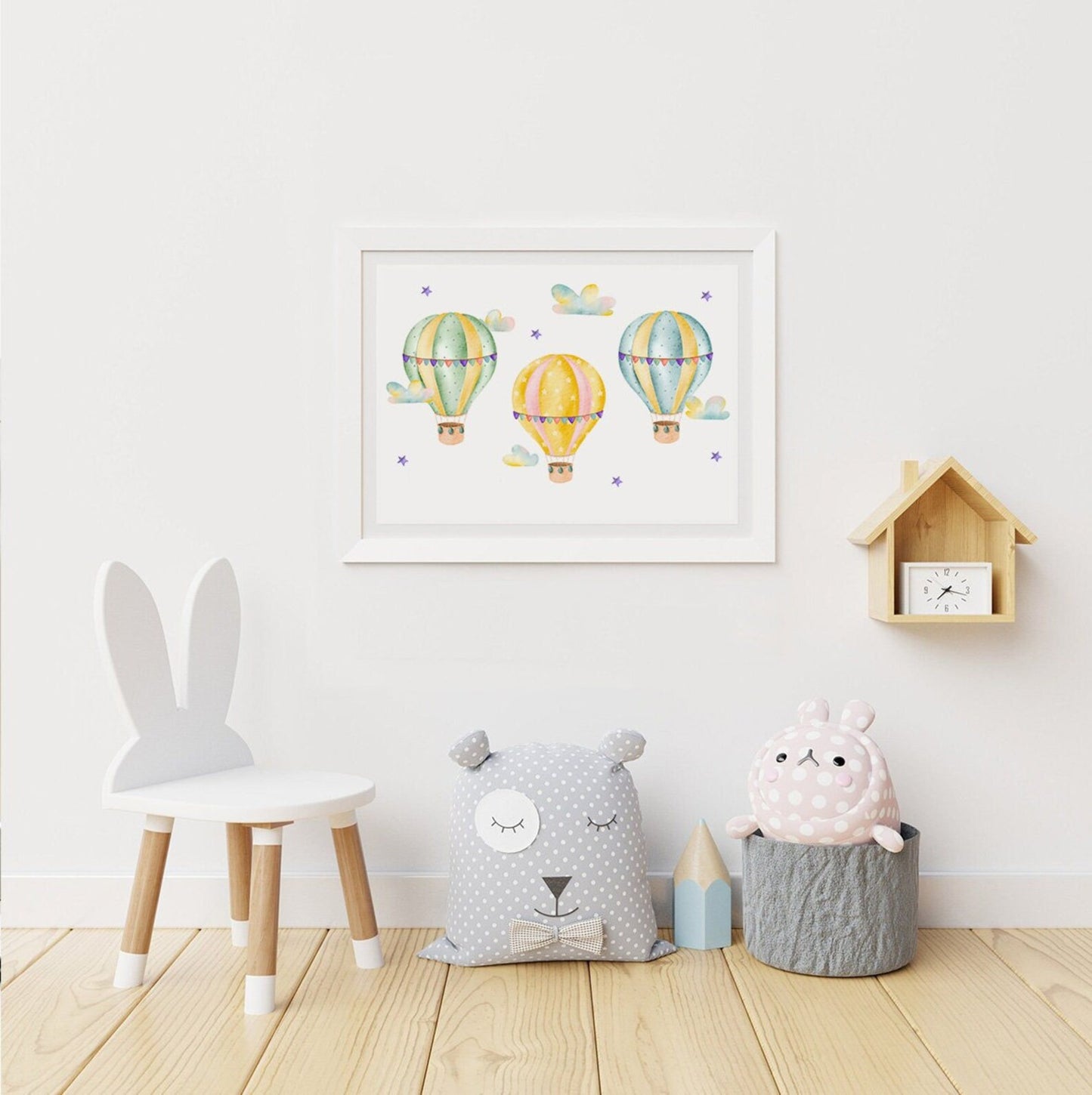Children's room with decorative pillows, a chair, and wall art.