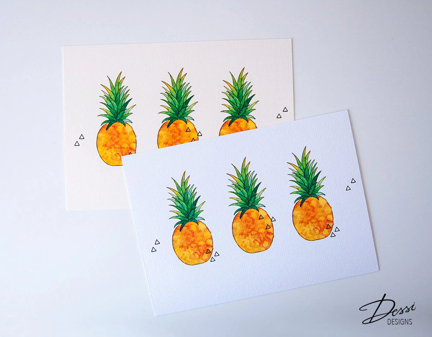 Two cards with pineapple illustrations on a light gray background