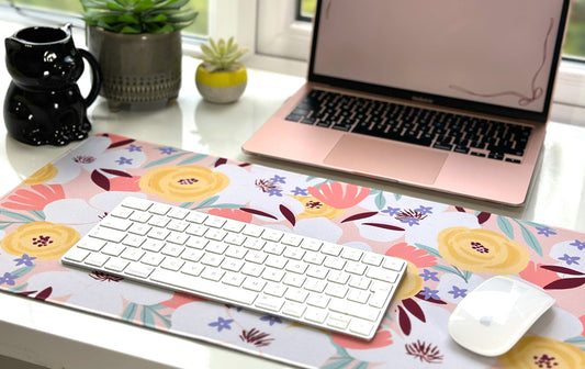 Desk mat with keyboard, mouse and MacBook.