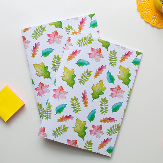 Two notebooks with colorful leaf pattern on a white surface