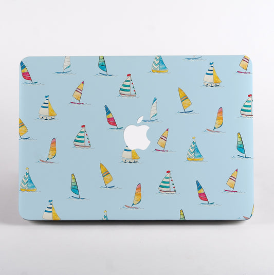 MacBook with colorful sailboat pattern case on a light blue background