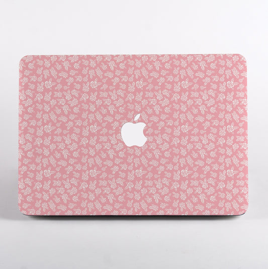 MacBook with Pink floral pattern and Apple logo Case on a light gray background