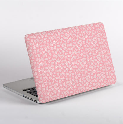 Side view of MacBook with Pink floral pattern and Apple logo Case on a light gray background