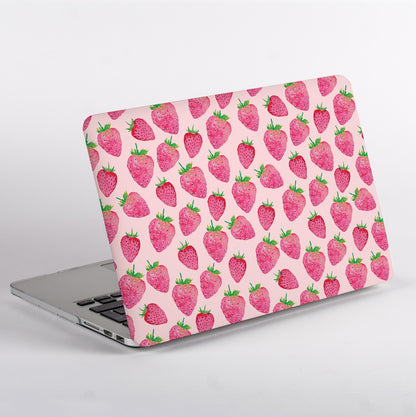Laptop with a strawberry patterned case on a light gray background