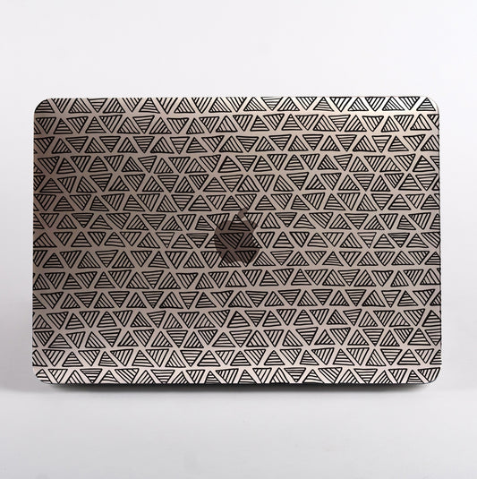 MacBook with a geometric triangle pattern clear case on a white background