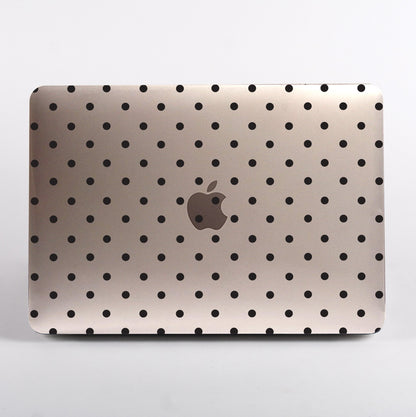 MacBook with black polka dot pattern clear case on a white background