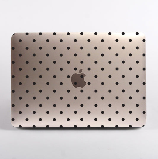 MacBook with black polka dot pattern clear case on a white background