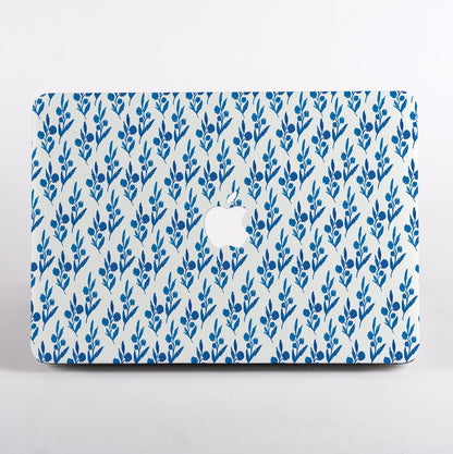 MacBook with blue leaf pattern case on a white background