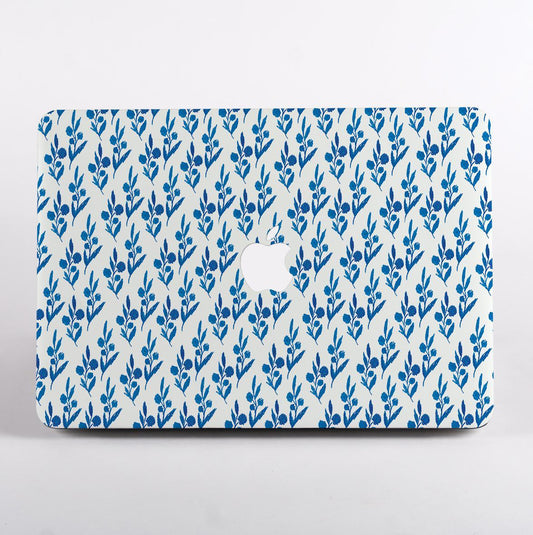 MacBook with blue leaf pattern case on a white background