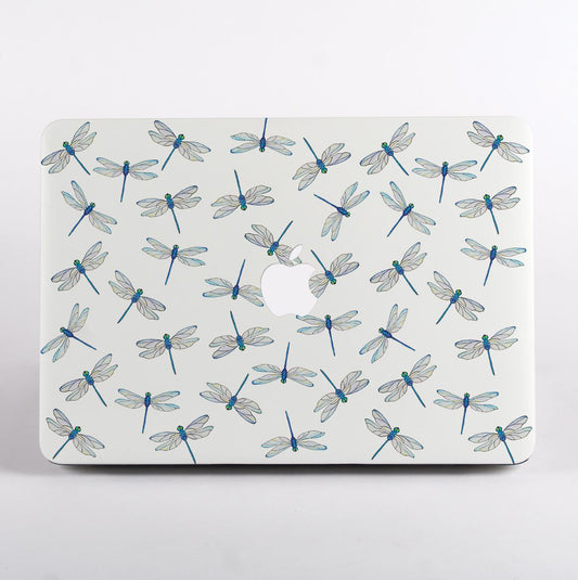 MacBook with dragonfly pattern case on a light gray background