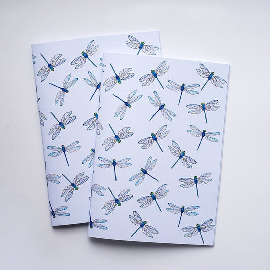 Two notebooks with dragonfly pattern on a white background
