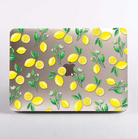 MacBook with a lemon and leaf pattern clear case on a grey background