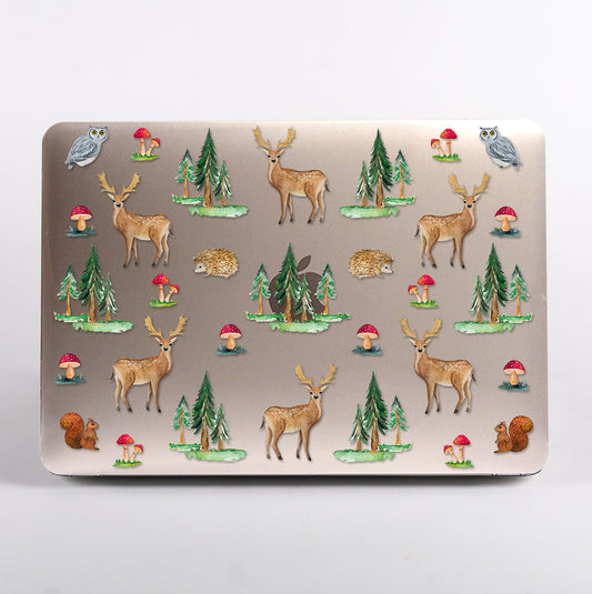 MacBook with a nature-themed design featuring deer, trees, and mushrooms clear case