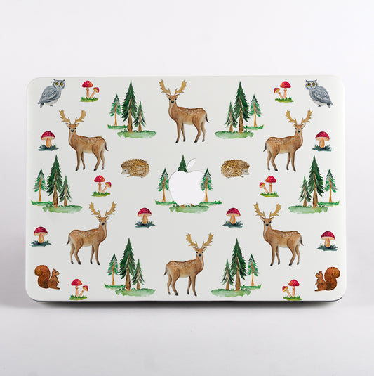 MacBook with a forest-themedMacBook Case featuring deer, trees, and mushrooms on a white background.