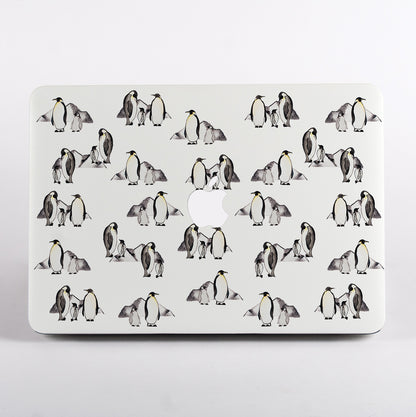 MacBook with a penguin patterned case on a white background