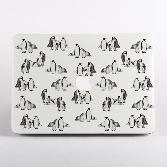 MacBook with a penguin patterned case on a white background