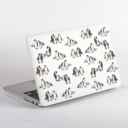 MacBook with penguin patterned case on a white background