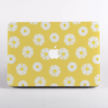 MacBook with a yellow case featuring white daisy pattern
