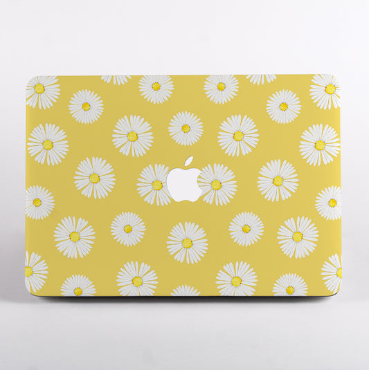 MacBook with a yellow case featuring white daisy pattern