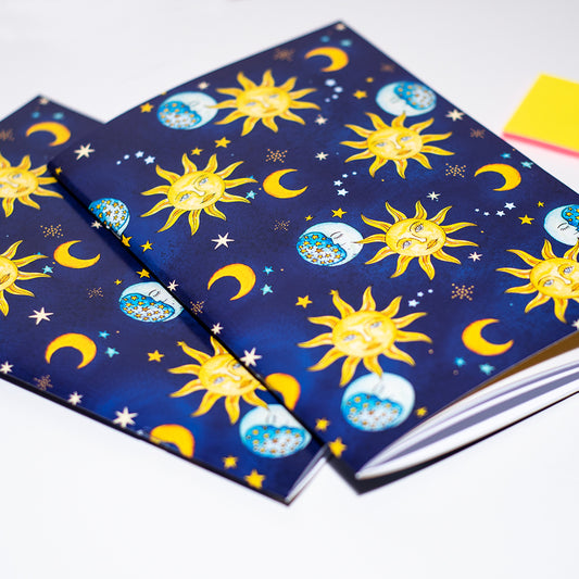 Notebooks with celestial pattern on a white background