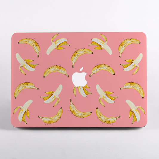 MacBook with a pink case featuring banana pattern