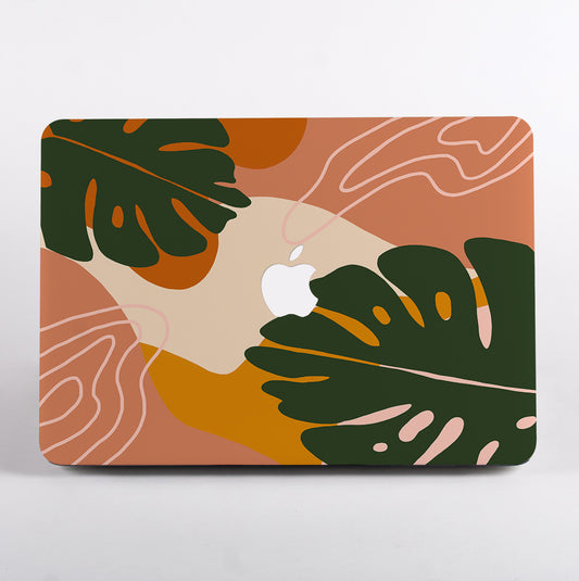 MacBook with a decorative case featuring green leaves and abstract patterns