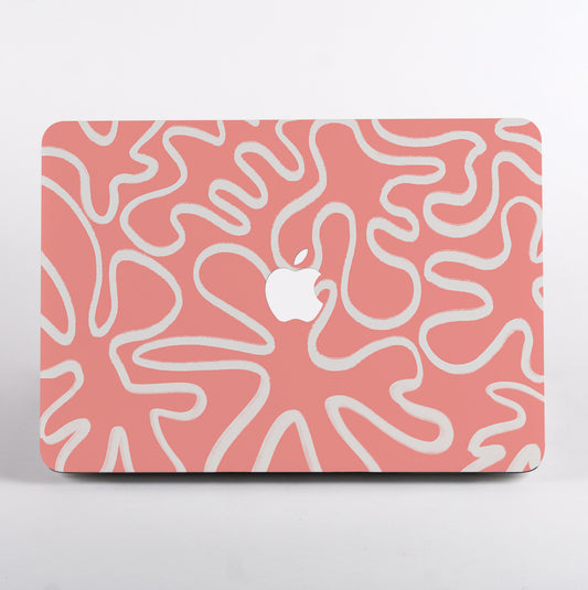 MacBook with a pink and white abstract pattern case